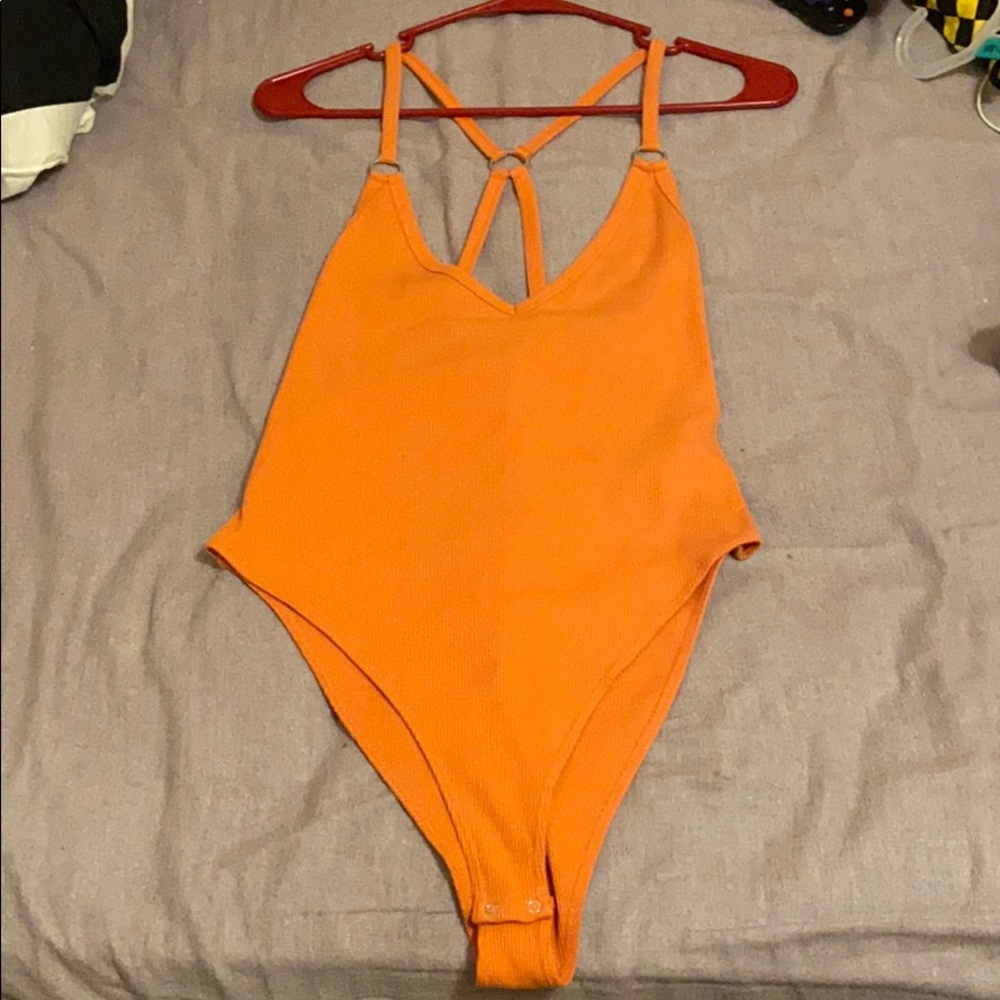 Coral body suit with ring detail.
